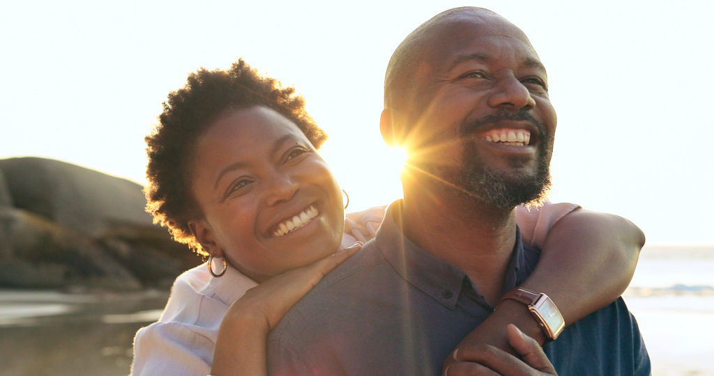 A couple embracing on the beach at sunset